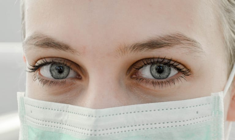 Photo by Ani Kolleshi closeup photo of woman's eye wearing mask
